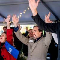 Event Attendees standing and holding hands in the air